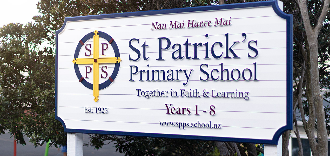 Carved sign for Saint Pats school