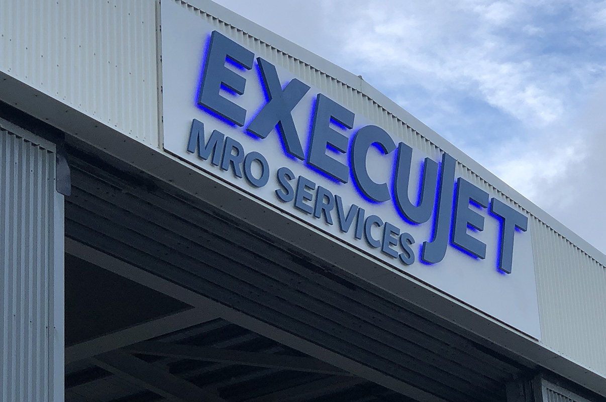 Execujet private jet hangar sign